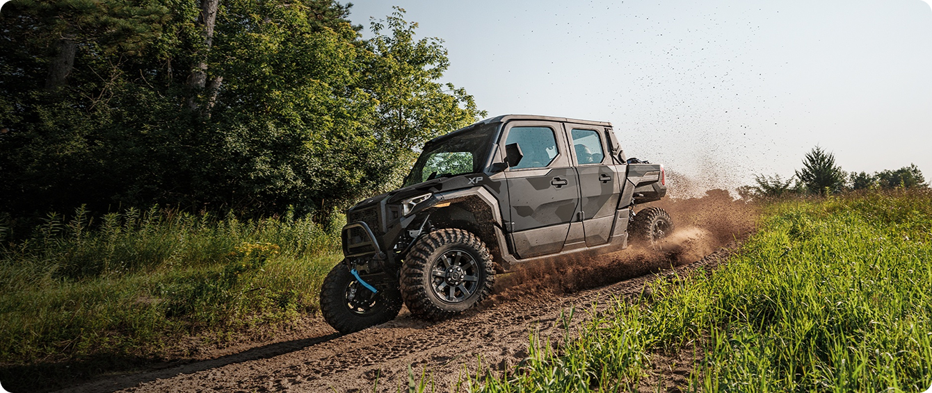 Off-road vehicle driving through a field